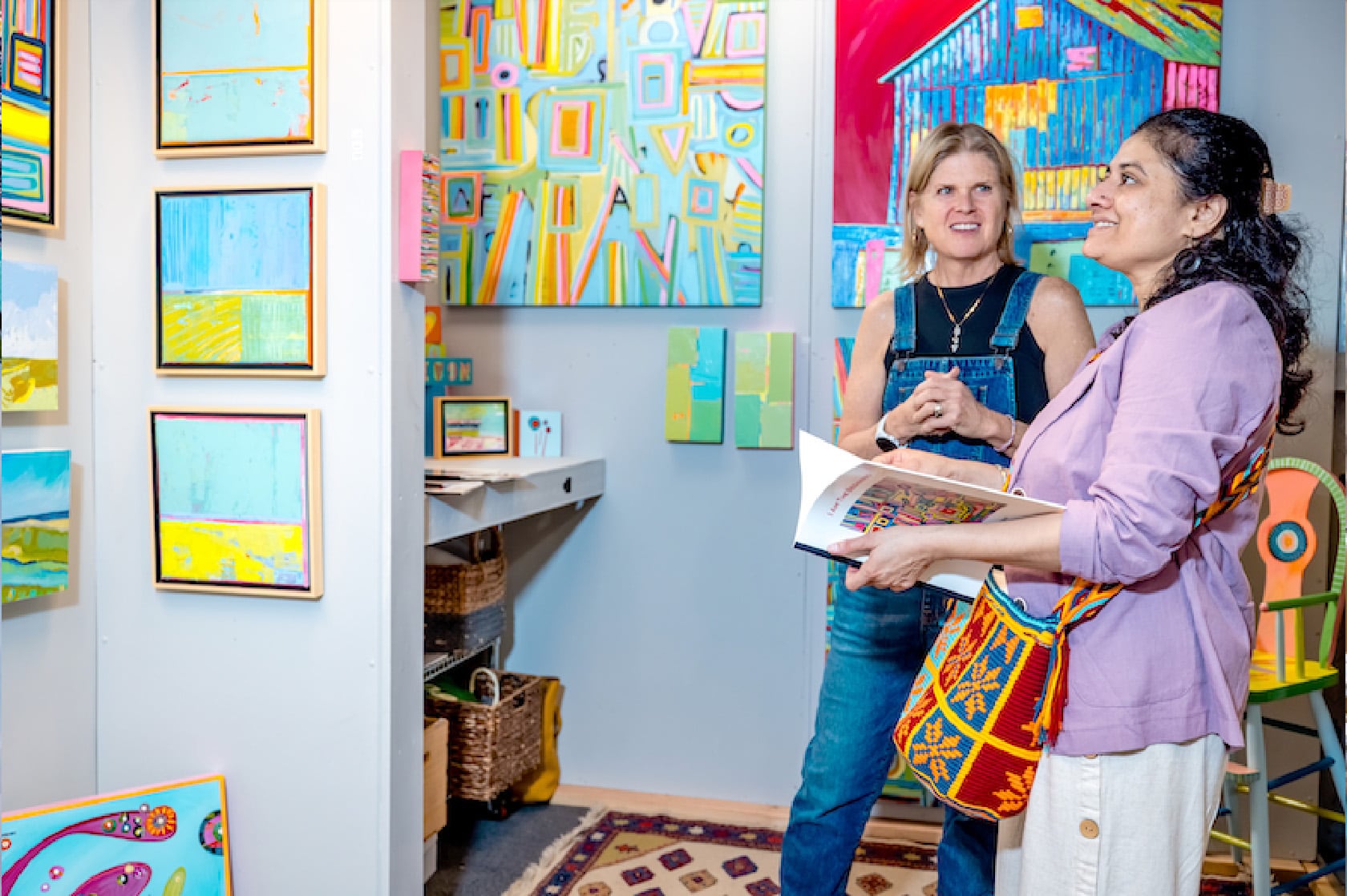 Artist and Patron looking at paintings